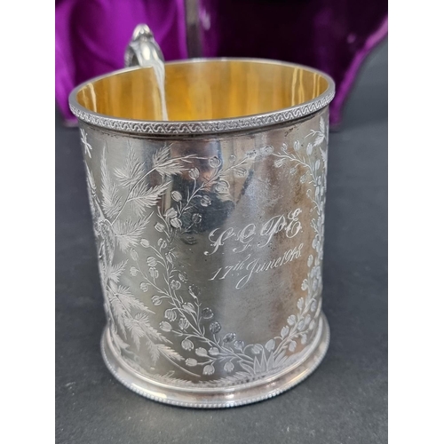 679 - A cased Victorian silver mug, having gilt interior, by Henry Holland, London 1876, 9cm high, 196g.... 