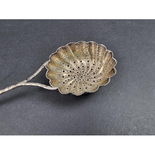 710 - A Chinese white metal sifter spoon, probably by Hung Chong & Co, 19.5cm long, 25g.... 