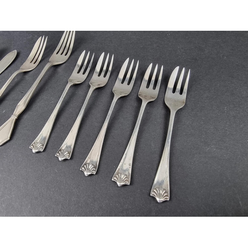 712 - A small group of silver cutlery; together with a silver napkin ring, 144g. (10)