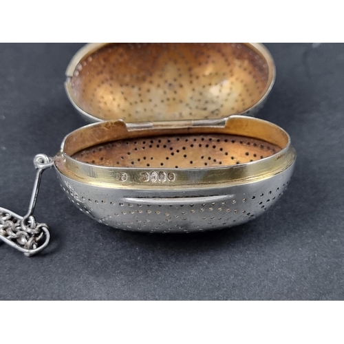 742 - A Victorian silver tea infuser, having gilt interior, with suspension chain and hook, by Thomas John... 