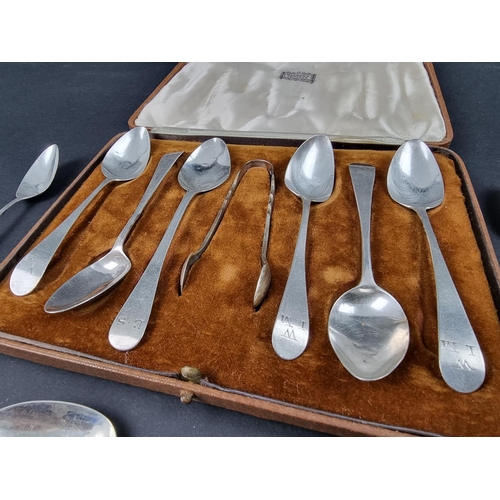 753 - Nine Georgian and later silver teaspoons, together with a pair of silver sugar tongs; a small white ... 