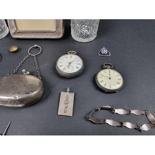 763 - A group of silver items, to include: two pocket watches; a purse; and a photograph frame.... 