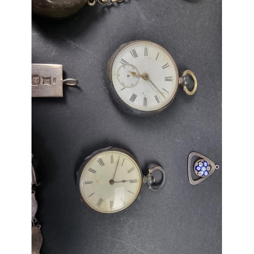 763 - A group of silver items, to include: two pocket watches; a purse; and a photograph frame.... 