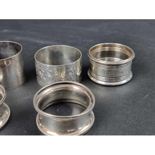 783 - A set of three silver napkin rings, by Francis Howard Ltd, Birmingham; together with five other silv... 