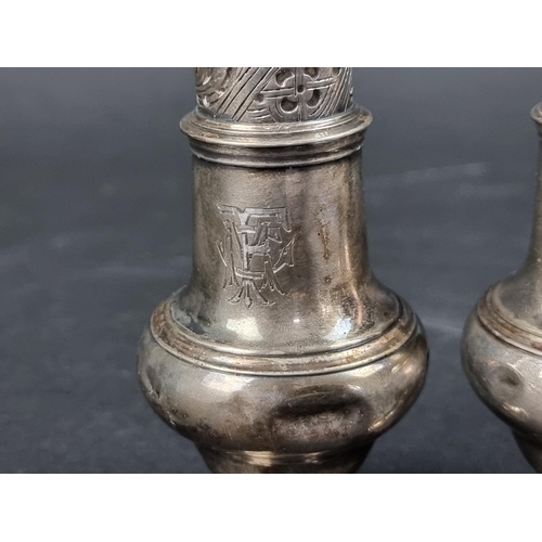 792 - A near pair of George III silver casters, by Jabez Daniell & James Mince, London 1771, 12cm high... 