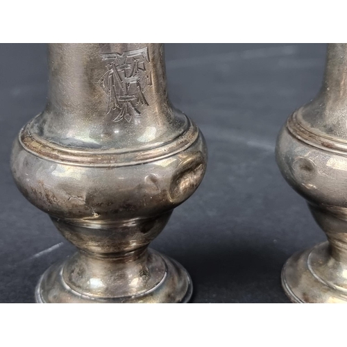 792 - A near pair of George III silver casters, by Jabez Daniell & James Mince, London 1771, 12cm high... 