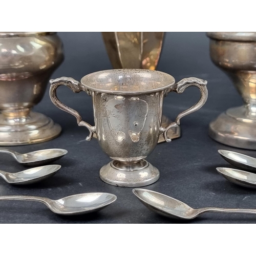 798 - A silver sugar caster, marks rubbed, 8.5cm high; together with a silver vase; a miniature trophy cup... 