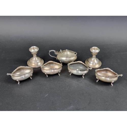 801 - A group of silver, to include: a set of four oval salts, with three spoons; a small pair of silver c... 