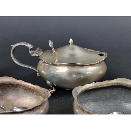 801 - A group of silver, to include: a set of four oval salts, with three spoons; a small pair of silver c... 