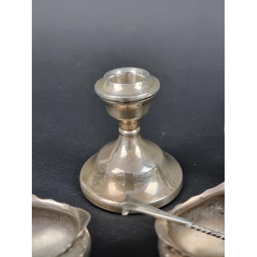 801 - A group of silver, to include: a set of four oval salts, with three spoons; a small pair of silver c... 