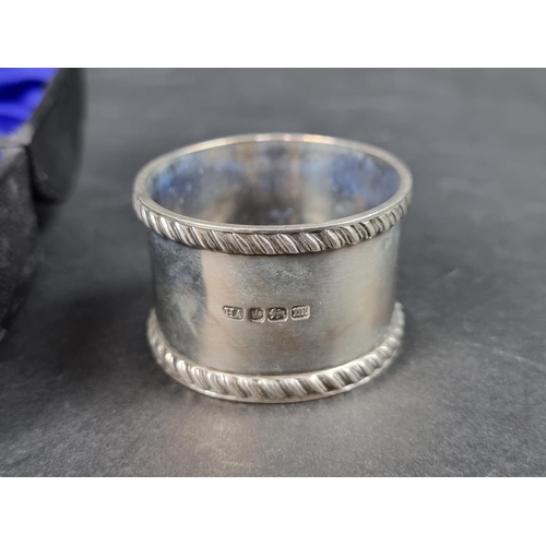 810 - A cased pair of Victorian silver napkin rings, by Atkin Brothers, Sheffield 1892; together with anot... 