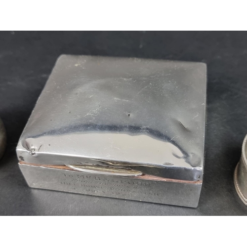 811 - A silver cigarette box; together with three silver napkin rings, 62g weighable. (4)