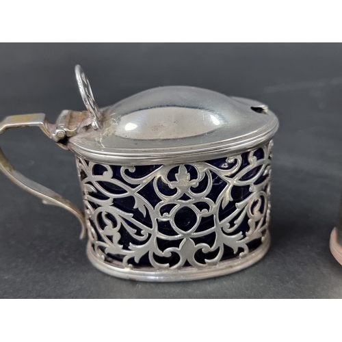 814 - A silver mustard pot, by Reid & Sons, London 1911, having blue glass liner and associated silver... 