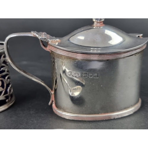 814 - A silver mustard pot, by Reid & Sons, London 1911, having blue glass liner and associated silver... 