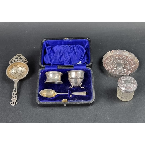 818 - A cased Edwardian silver egg cup, spoon and napkin ring, by CJ DF, London 1911; together with a silv... 