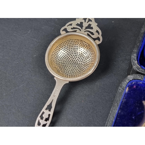 818 - A cased Edwardian silver egg cup, spoon and napkin ring, by CJ DF, London 1911; together with a silv... 