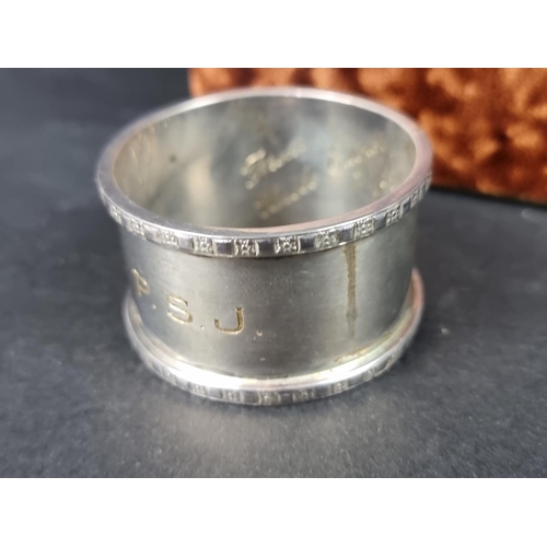 825 - Two cased silver napkin rings; together with a silver cigarette case; and a silver locket, gross wei... 