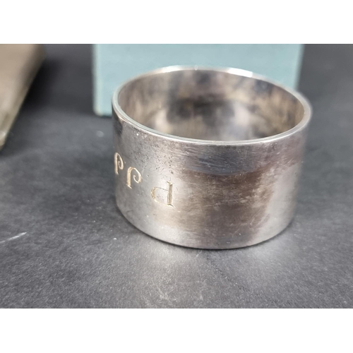 825 - Two cased silver napkin rings; together with a silver cigarette case; and a silver locket, gross wei... 