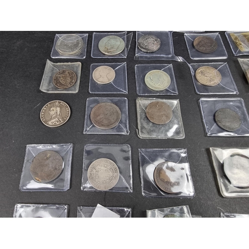 877 - Coins: a quantity of UK and world coins, to include a 1935 rocking horse crown.