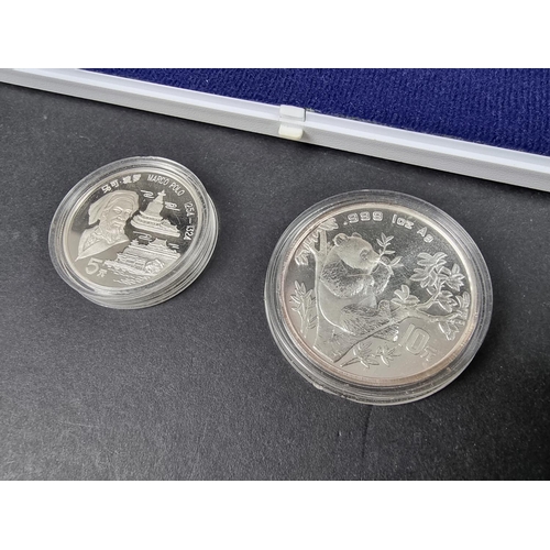 885 - Coins: a Chinese 1995 .999 silver 1oz 10 Yuan Panda coin; together with a Chinese 1992 silver 5 Yuan... 