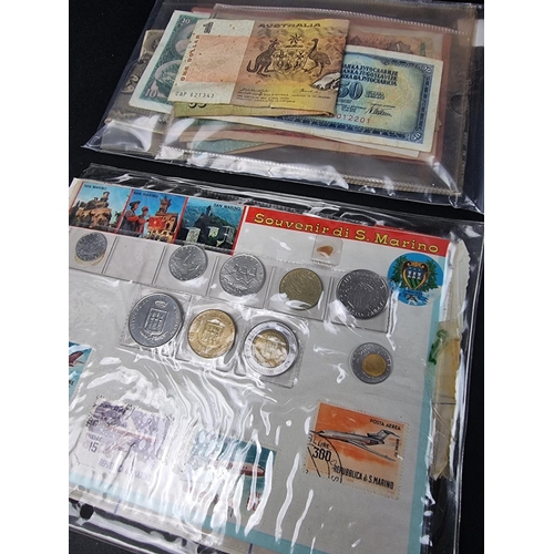 900 - Coins: a large quantity of UK and world coins, in two albums and loose.