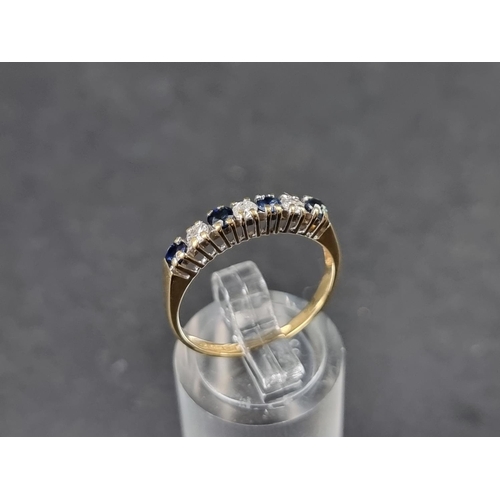 921 - An 18ct gold half eternity ring, set four sapphires and three brilliant cut diamonds, Birmingham 198... 