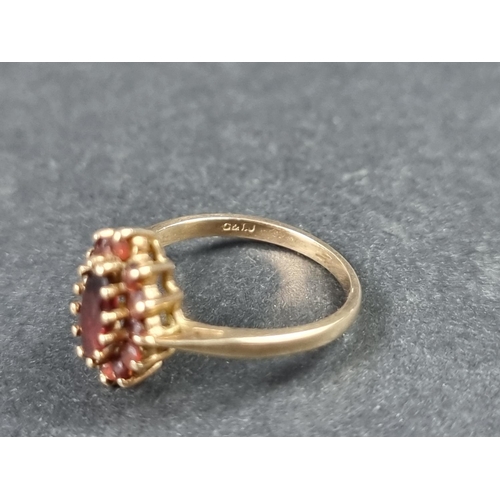 924 - A 9ct gold garnet cluster ring, size N 1/2; together with another 9ct gold garnet ring, size J 1/2, ... 