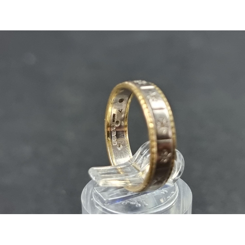 927 - An 18ct white and yellow gold eternity ring, set diamond chips, size N, gross weight 3.8g.... 