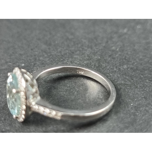 932 - A white metal ring, set central faceted aquamarine of approx. 2.60ct, surrounded by small brilliant ... 