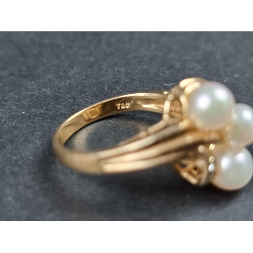 934 - A yellow metal ring, set three pearls and three small diamonds, stamped 14k, size L.... 