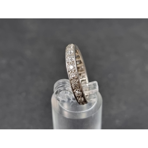 936 - A white metal diamond eternity ring, size P.