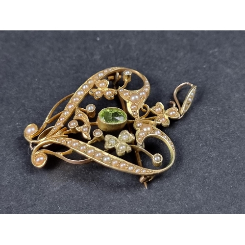 945 - A late Victorian yellow metal peridot and pearl heart brooch/pendant, engraved '15ct', 16mm high inc... 