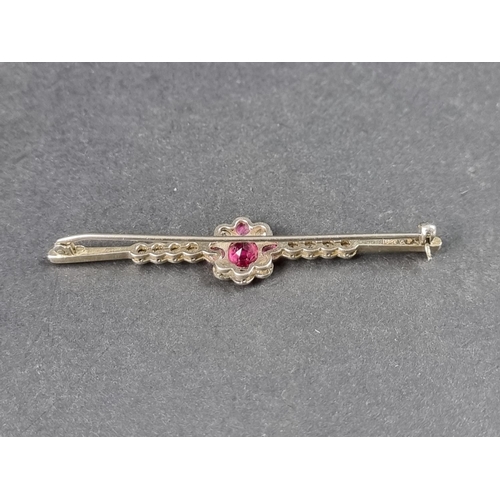 946 - A 1920s ruby and diamond set bar brooch, stamped 18ct/Plat, with a floral cluster of four rubies and... 