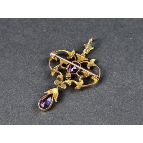 947 - An Edwardian yellow metal pendant/brooch, set two amethysts and seed pearls, 56mm high x 33mm wide.... 