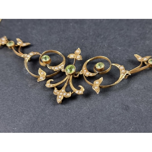 948 - An Edwardian yellow metal peridot and seed pearl necklace, stamped 9ct, 39cm long.