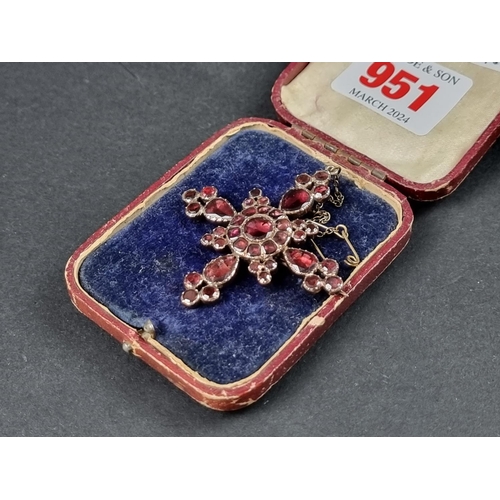 951 - An early 19th century Bohemian foiled garnet cross pendant/brooch, 51 x 47mm.