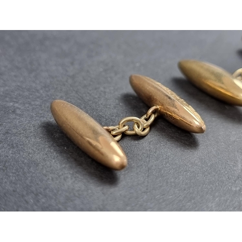 967 - A pair of yellow metal torpedo shaped cufflinks, stamped 18, 24mm.