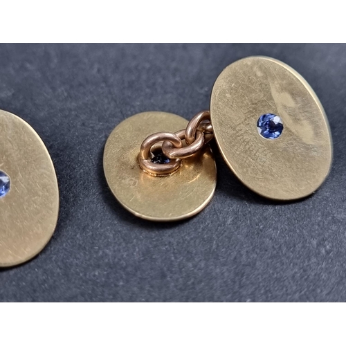 979 - A pair of yellow metal cufflinks, each set sapphire, stamped 15, 17mm.