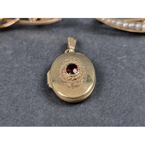 981 - A 9ct gold locket, set garnet, 20mm high; together with a yellow metal crescent brooch, set seed pea... 