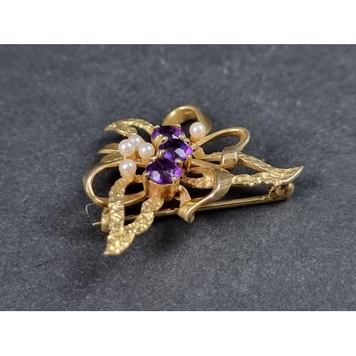 986 - A 9ct gold brooch, set three amethysts and five pearls, 34mm wide, gross weight 6.9g.... 