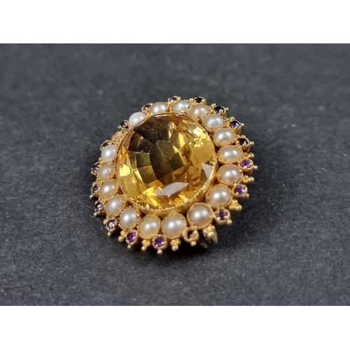 991 - A yellow metal brooch, set citrine with a border of split pearls and amethysts, 32mm wide.... 