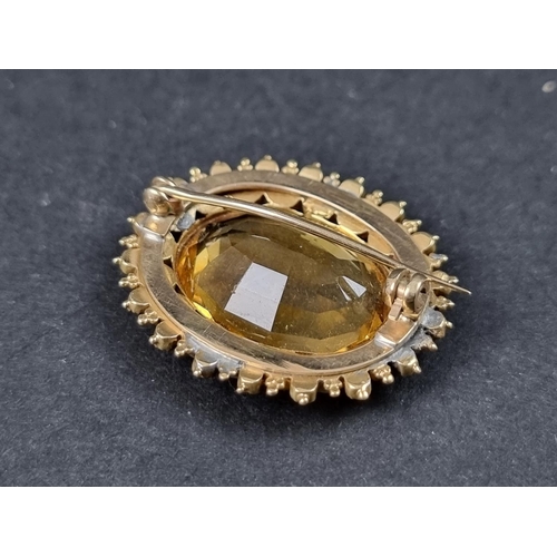 991 - A yellow metal brooch, set citrine with a border of split pearls and amethysts, 32mm wide.... 