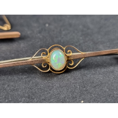 992 - A yellow metal bar brooch, set central oval cabochon opal, stamped 9ct, 6.6cm long; together with an... 