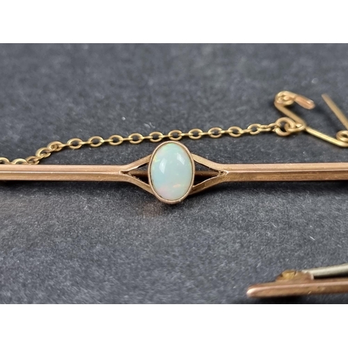 992 - A yellow metal bar brooch, set central oval cabochon opal, stamped 9ct, 6.6cm long; together with an... 