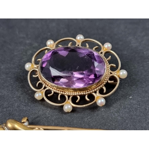 993 - A 9ct gold brooch, set faceted amethyst with eight small pearls, in an openwork setting, 35mm wide; ... 