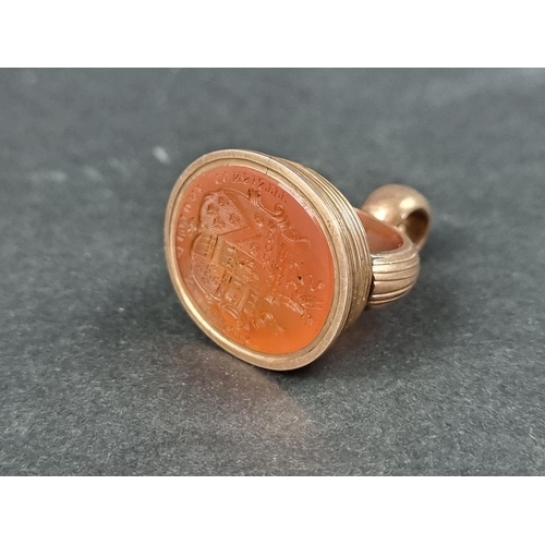 995 - A 19th century yellow metal fob seal, set carnelian intaglio carved crest, 34mm high.... 