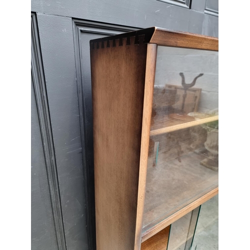 1012 - A mahogany bookcase, with glass sliding doors, 91.5cm wide, labelled Herbert E Gibbs.... 