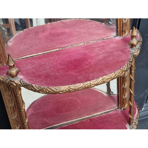 1030 - An old giltwood and mirrored glass wall shelf, 106cm high. 