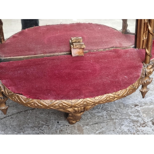 1030 - An old giltwood and mirrored glass wall shelf, 106cm high. 