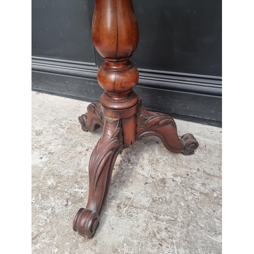 1034 - A Victorian mahogany tripod table, with quarter veneered top, 68cm wide.